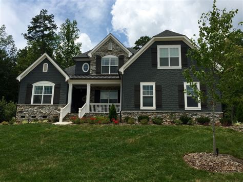 grey house with brown metal roof|grey houses with black shutters.